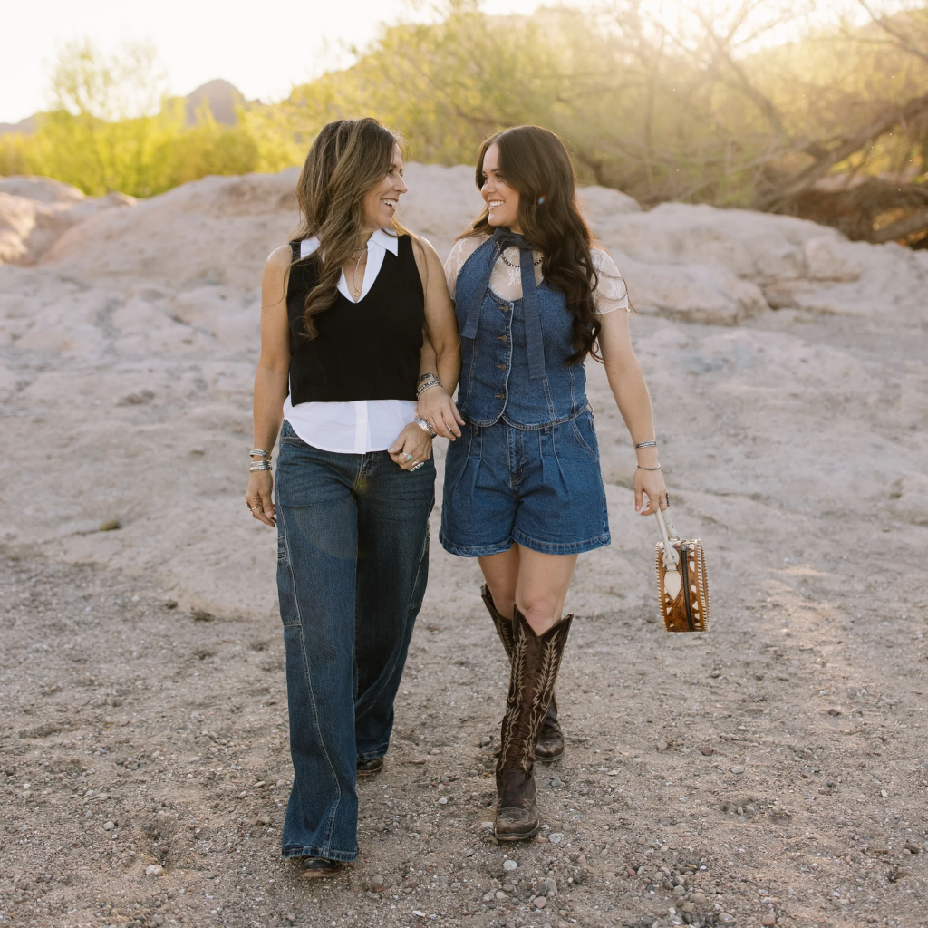 Two women walking together in a natural setting with a blurred background | Crooked Horn Company | San Tan Valley, AZ