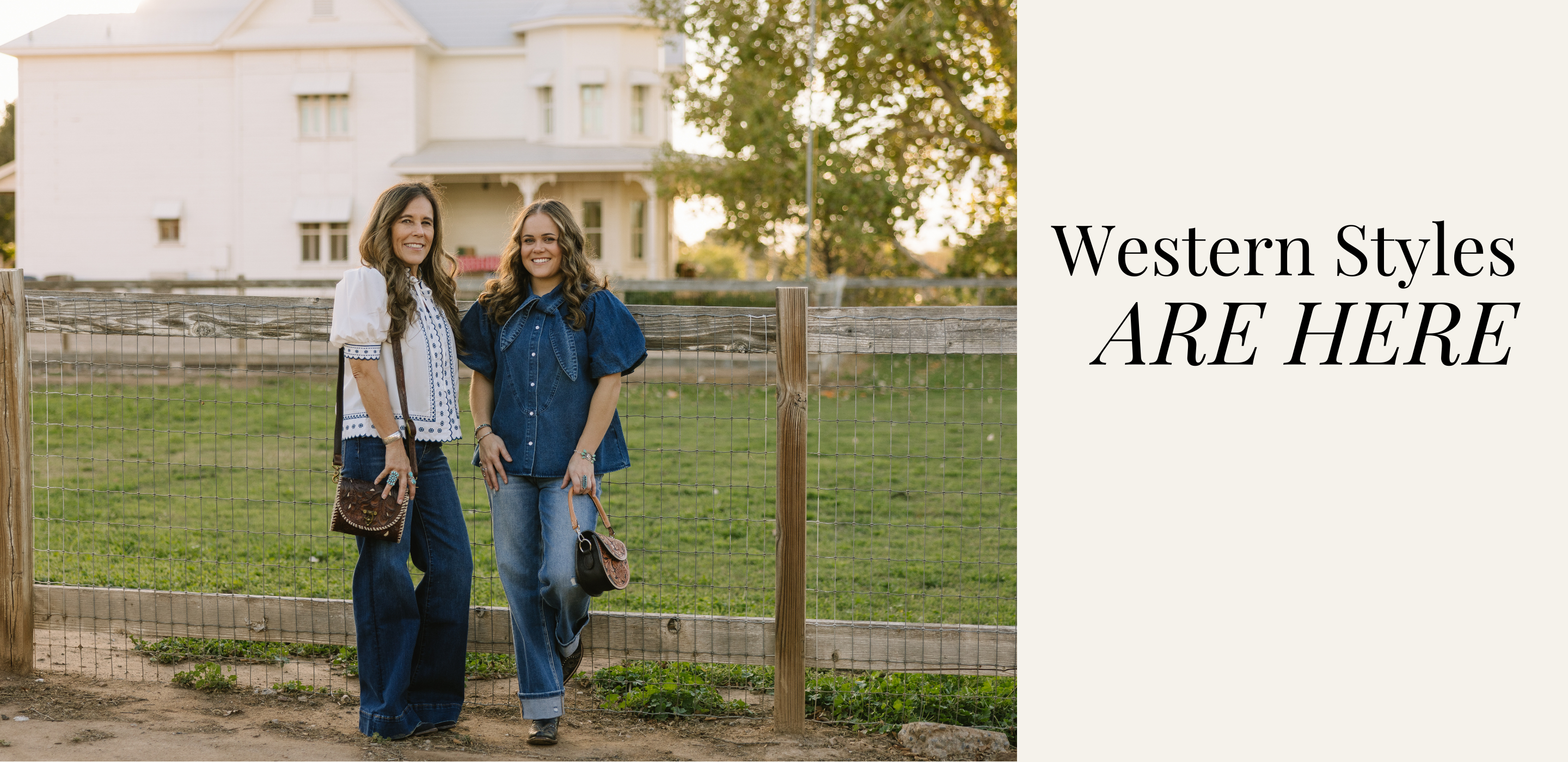 Two women wearing a white textured blouse and one wearing a denim blouse in front of a white house and fence with text 'Western Styles ARE HERE' | Crooked Horn Co | Mesa, AZ
